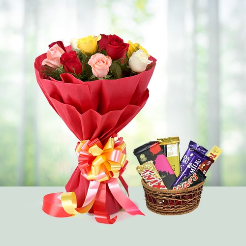 Bunch of roses with assorted chocolates in basket 